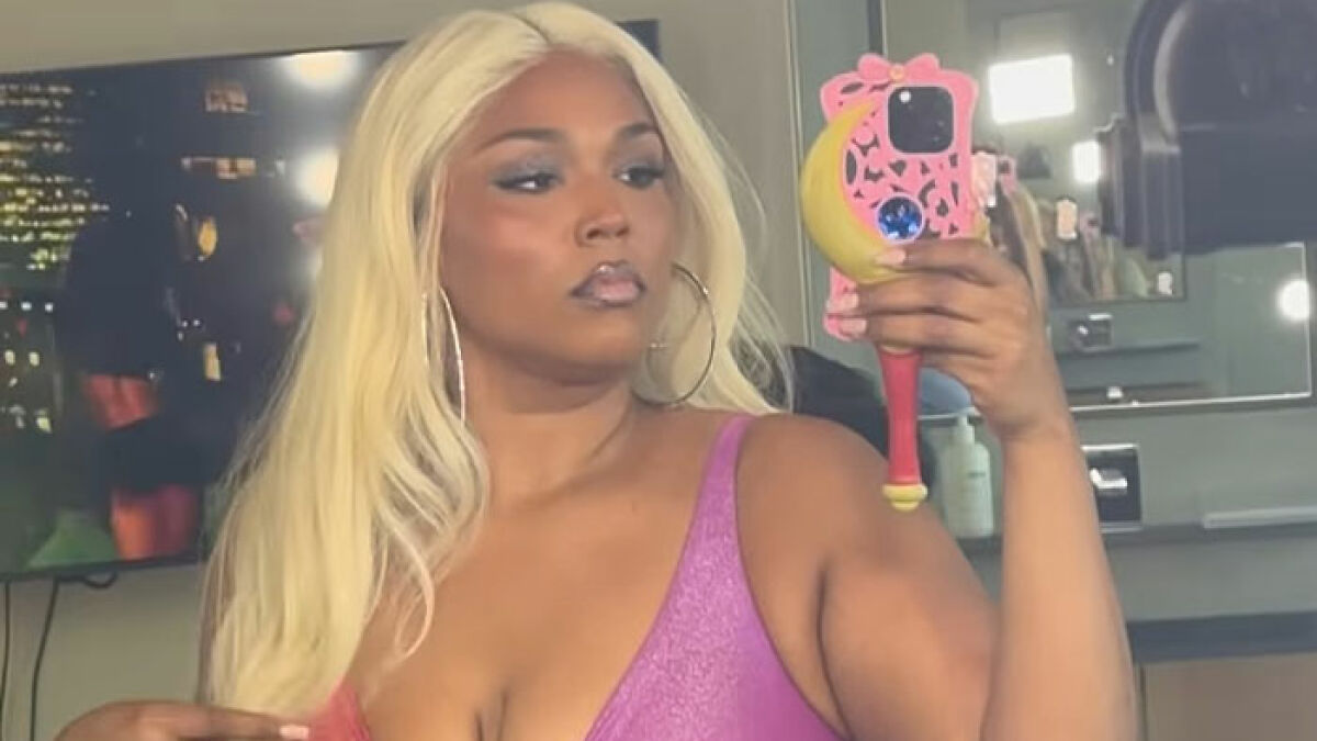 Lizzo in a tiny swimsuit showing off her mermaid Ozempic body during a mirror selfie indoors.