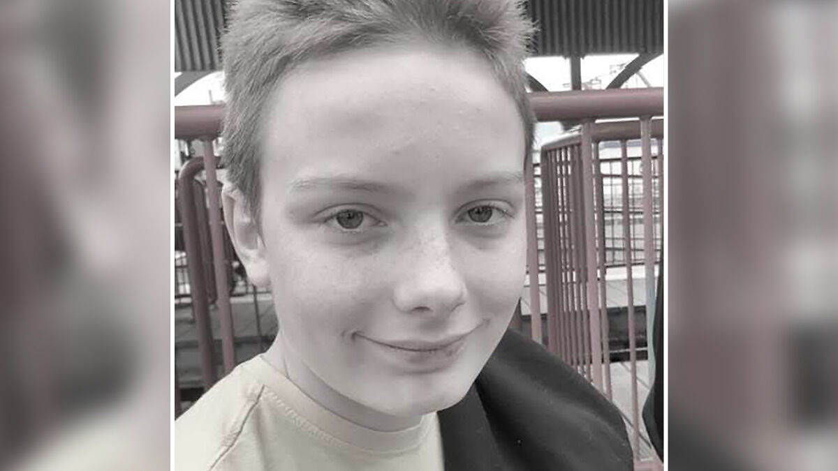 Young boy outdoors near railings, close-up portrait highlighting viral scarf challenge risks for children.