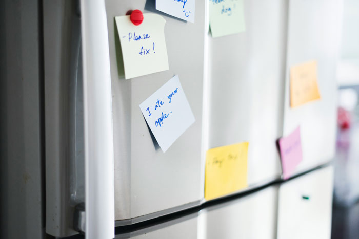 Refrigerator with handwritten labels added by workers to protect their food from a lunch thief in the office. Refrigerator with handwritten labels added by workers to protect their food from a lunch thief in the office.