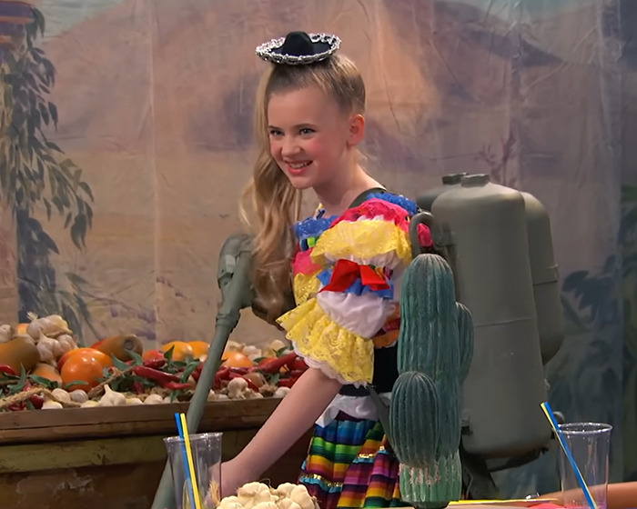 Child star in colorful costume with a backpack device, smiling amid a festive setting highlighting unrecognizable transformation concerns. Child star in colorful costume with a backpack device, smiling amid a festive setting highlighting unrecognizable transformation concerns.