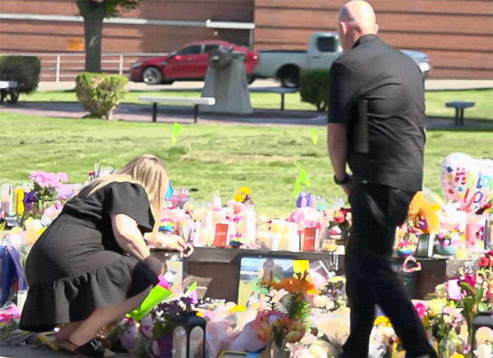 People paying respects at a memorial filled with flowers and candles where blood not belonging to a human was found. People paying respects at a memorial filled with flowers and candles where blood not belonging to a human was found.