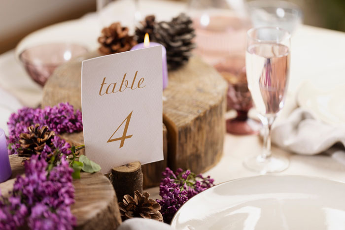 Wedding table setting with floral decorations, highlighting mother of ring bearer left off guest list despite RSVP and help Wedding table setting with floral decorations, highlighting mother of ring bearer left off guest list despite RSVP and help