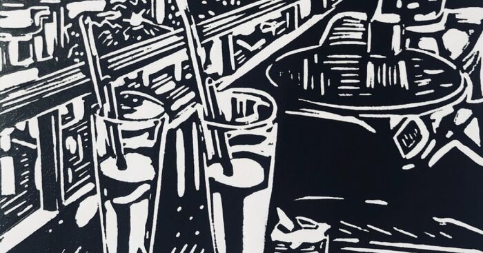 Black and white linocut artwork depicting a Vietnamese street scene with tables, chairs, and drinks by a British artist.