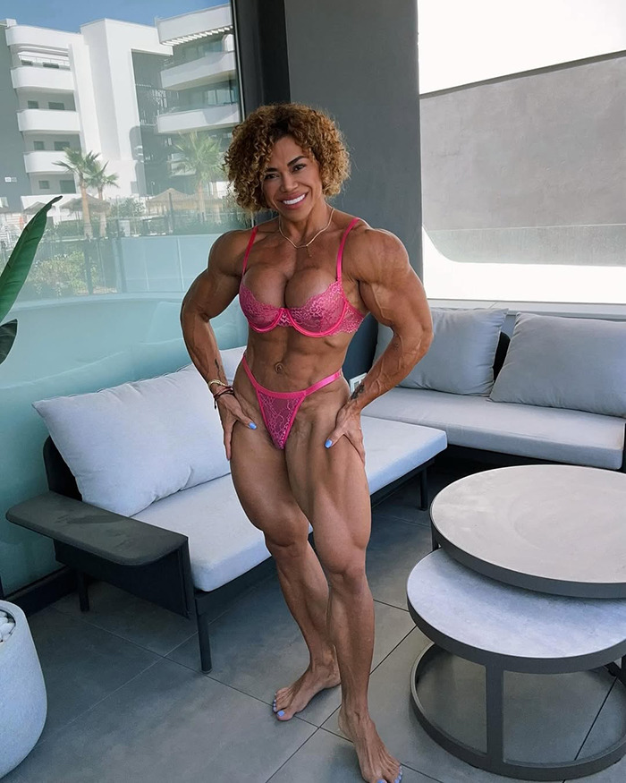 Female bodybuilder with muscular physique posing in pink lingerie on a balcony, representing bodybuilder dubbed She Hulk. Female bodybuilder with muscular physique posing in pink lingerie on a balcony, representing bodybuilder dubbed She Hulk.