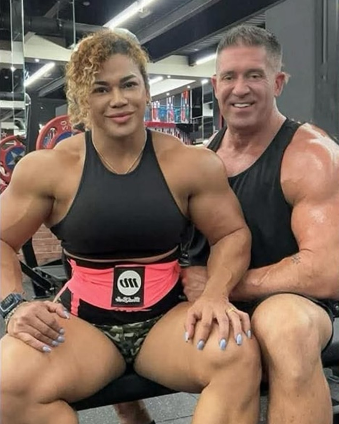 Bodybuilder woman and muscular man posing in gym, highlighting strength and fitness in a workout environment. Bodybuilder woman and muscular man posing in gym, highlighting strength and fitness in a workout environment.