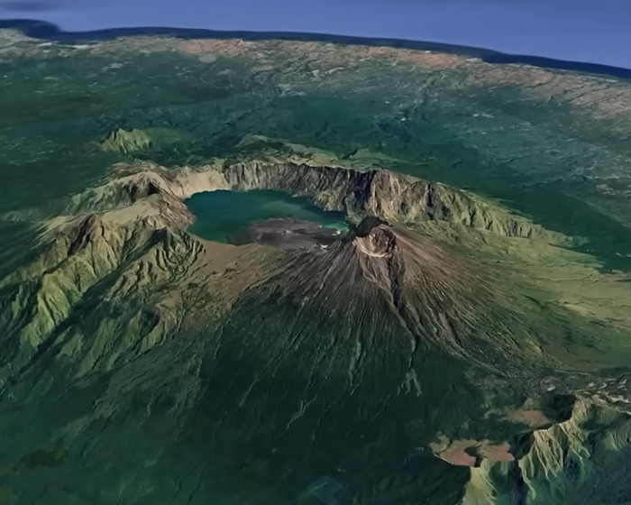 Aerial view of an active volcano with a crater lake, illustrating the site where a tourist was trapped inside the volcano. Aerial view of an active volcano with a crater lake, illustrating the site where a tourist was trapped inside the volcano.
