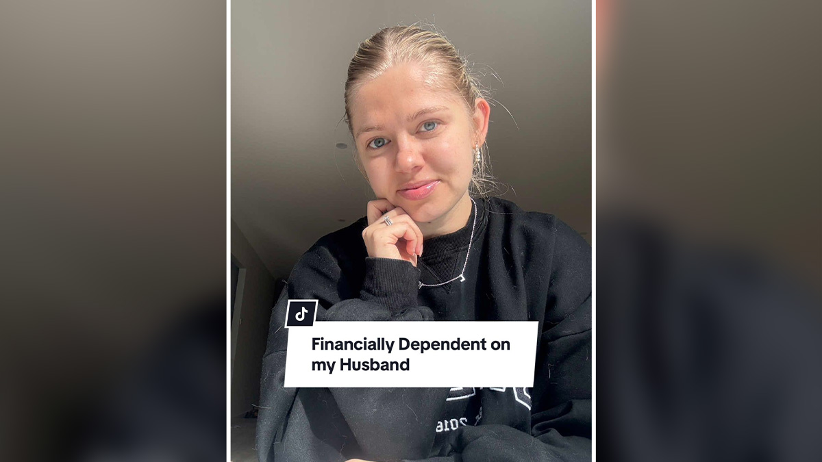 Young woman in black sweatshirt sharing her perspective about being financially dependent on her husband in a casual setting.