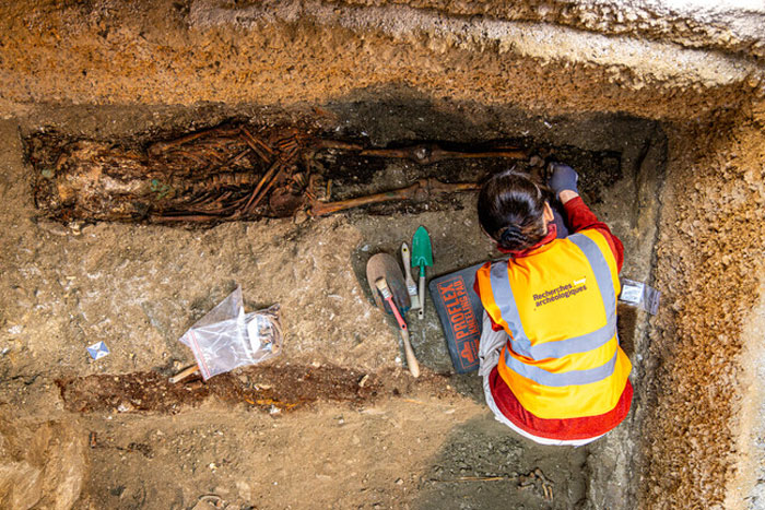 Archaeologist carefully excavating a 400-year-old burial vault accidentally discovered during church restoration works. Archaeologist carefully excavating a 400-year-old burial vault accidentally discovered during church restoration works.