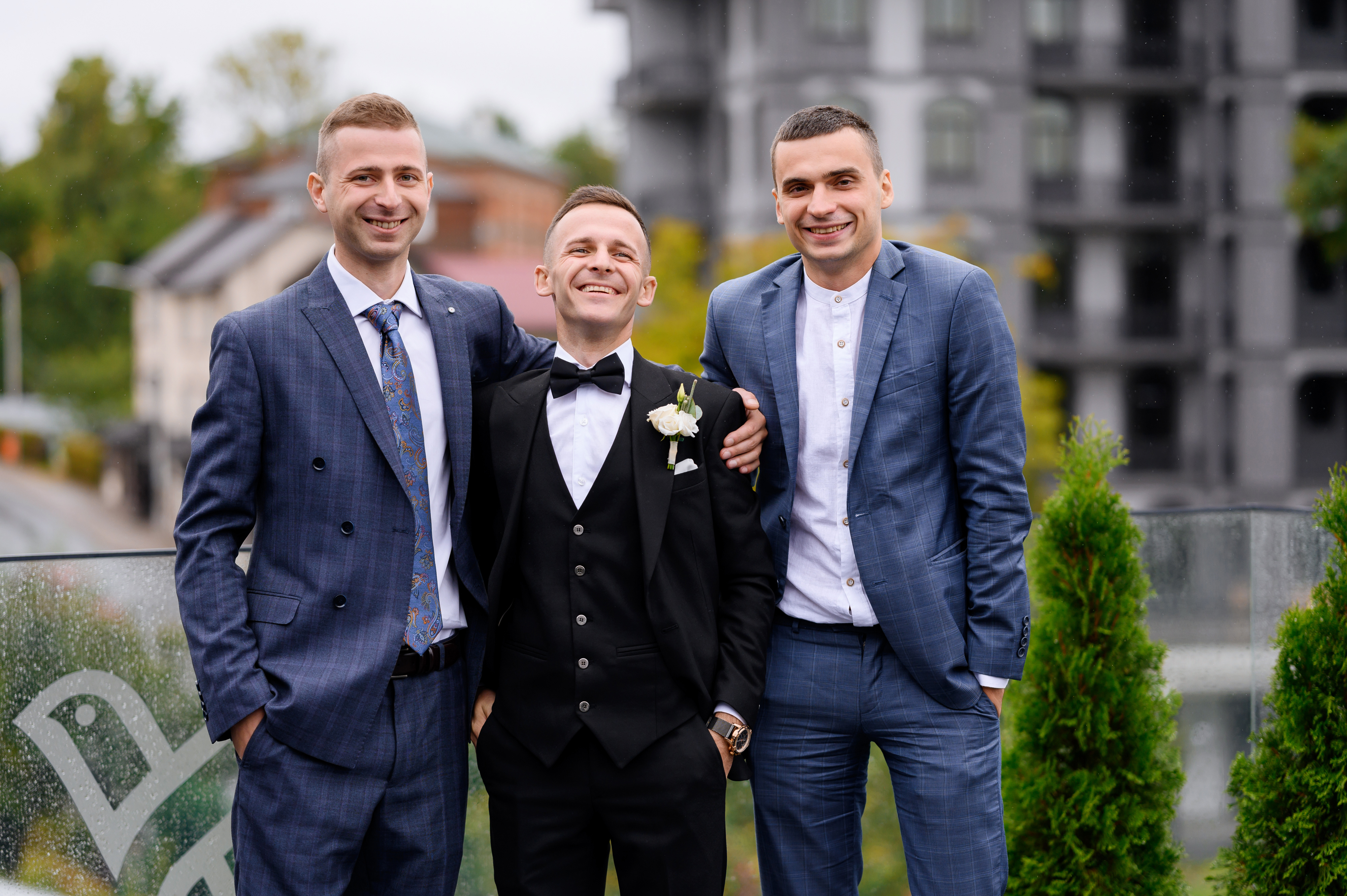 Three men in formal suits posing outside, representing excluding best man wedding photos over outfit concerns. Three men in formal suits posing outside, representing excluding best man wedding photos over outfit concerns.