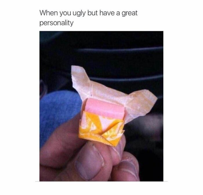 Hand holding a partially unwrapped pink Starburst candy with caption about having a great personality funny meme.