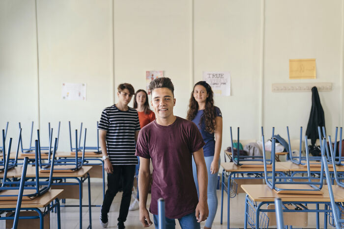 Teenagers in a classroom setting illustrating the nose-diving abilities of the younger generations, as shared by teachers.