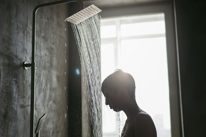 Silhouette of a young person standing under a shower, illustrating the nose-diving abilities of the younger generations.