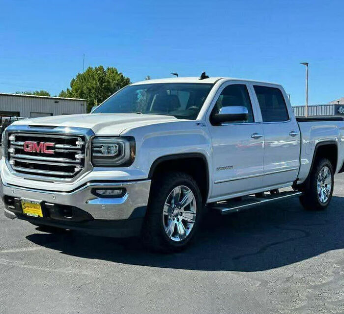 White GMC pickup truck parked outdoors on a sunny day related to bodies of 3 missing sisters found case. White GMC pickup truck parked outdoors on a sunny day related to bodies of 3 missing sisters found case.