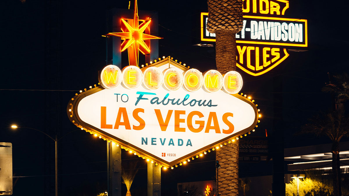 Night view of the iconic Welcome to Fabulous Las Vegas Nevada sign illuminated with neon lights.