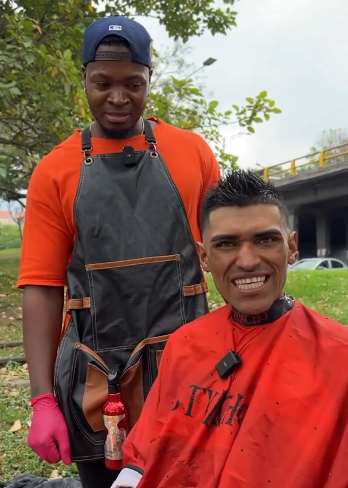 Barber giving a makeover to a homeless man outdoors, with viral reactions over potential model downgrade. Barber giving a makeover to a homeless man outdoors, with viral reactions over potential model downgrade.