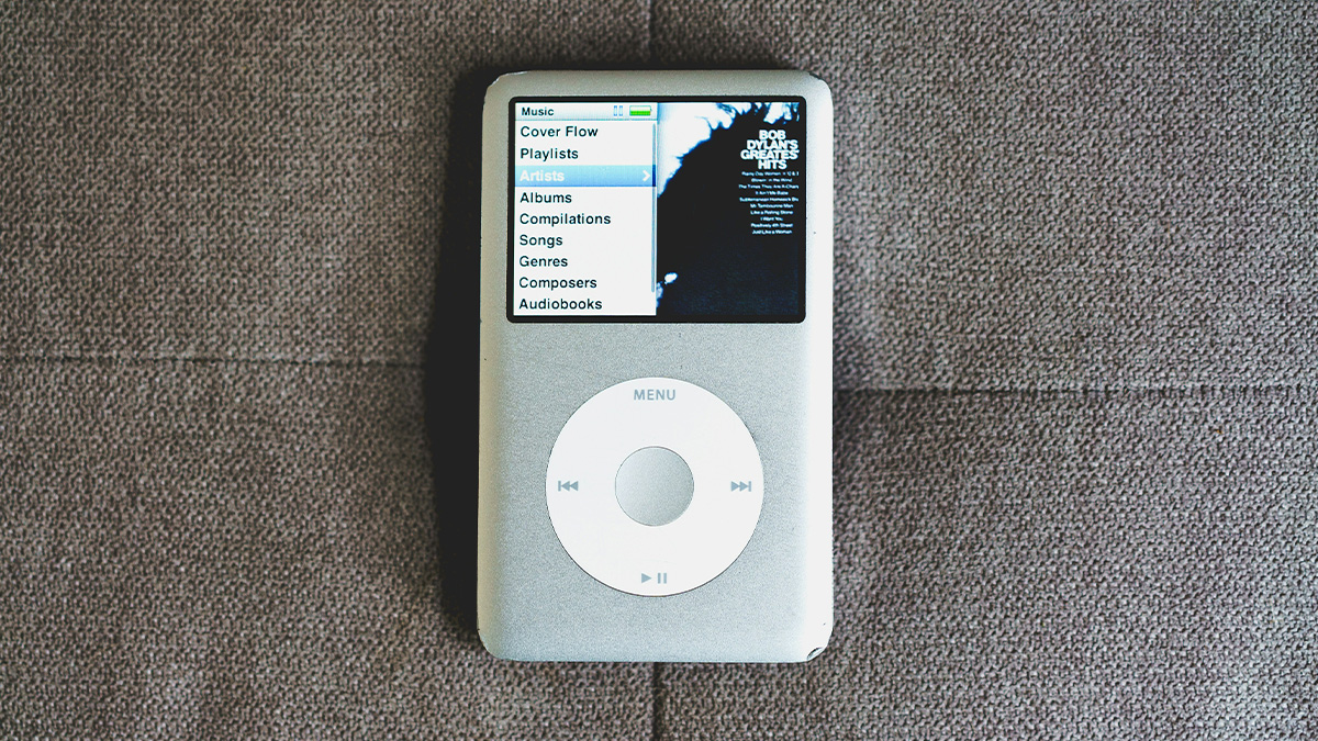 Vintage iPod music player showing menu on screen, illustrating still use daily of obsolete technology.