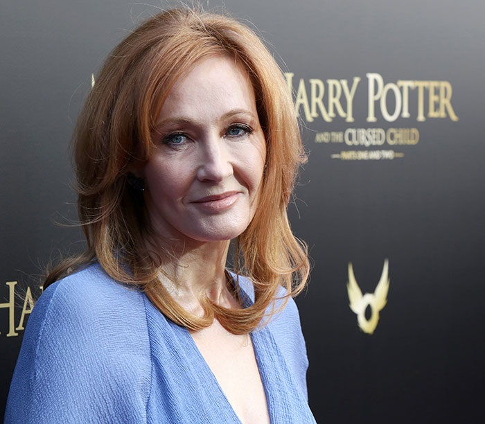 J.K. Rowling smiling on the Harry Potter and the Cursed Child red carpet event with fans in attendance. J.K. Rowling smiling on the Harry Potter and the Cursed Child red carpet event with fans in attendance.