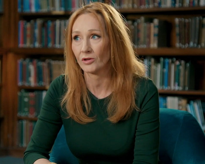 Author J.K. Rowling seated in a library speaking during an interview about Harry Potter fans and Tom Felton comments. Author J.K. Rowling seated in a library speaking during an interview about Harry Potter fans and Tom Felton comments.