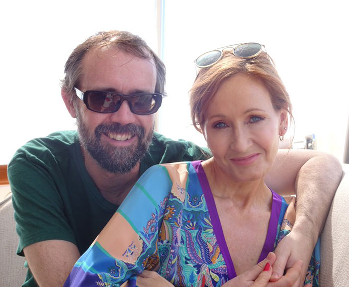 Stephen Fry smiling with sunglasses and J.K. Rowling in a colorful dress, highlighting Stephen Fry and J.K. Rowling SEO keywords. Stephen Fry smiling with sunglasses and J.K. Rowling in a colorful dress, highlighting Stephen Fry and J.K. Rowling SEO keywords.