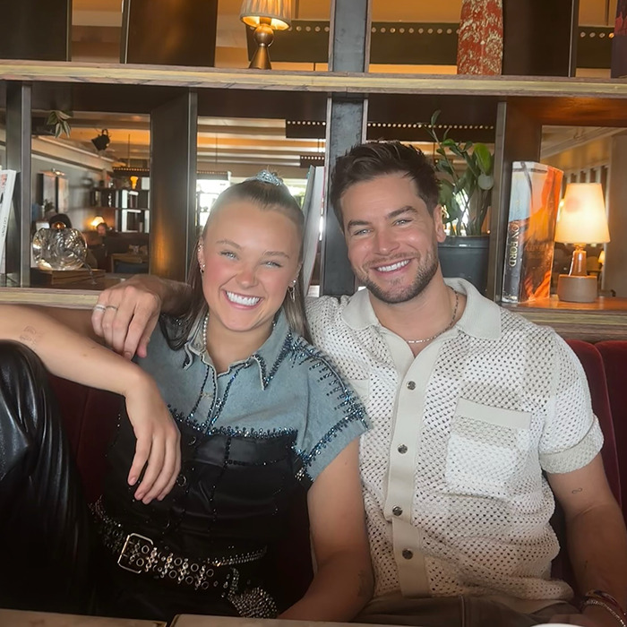 JoJo Siwa and partner smiling in casual outfits, sparking conversation about orientation and Pride Month backlash. JoJo Siwa and partner smiling in casual outfits, sparking conversation about orientation and Pride Month backlash.