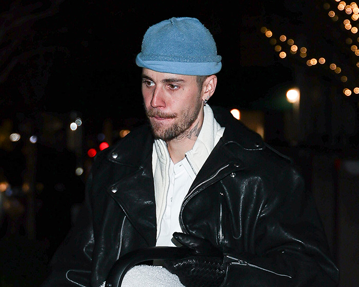 Justin Bieber looking somber wearing a blue beanie and leather jacket during a nighttime outing after aggressive meltdown. Justin Bieber looking somber wearing a blue beanie and leather jacket during a nighttime outing after aggressive meltdown.