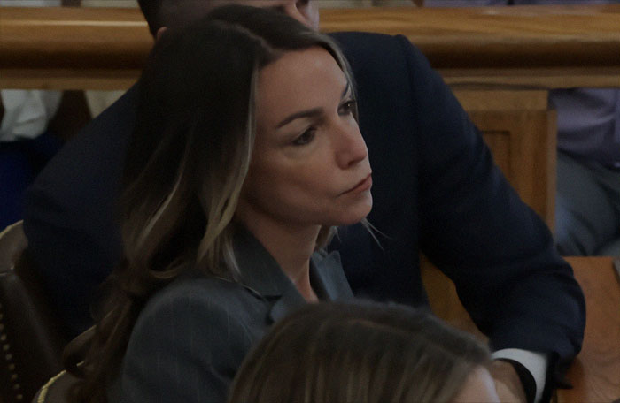 Karen Read attending trial proceedings, appearing contemplative and serious in a courtroom setting during acquittal case. Karen Read attending trial proceedings, appearing contemplative and serious in a courtroom setting during acquittal case.