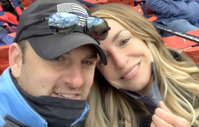 Karen Read and a man smiling close together at an outdoor event, related to trial acquittal and mass fury. Karen Read and a man smiling close together at an outdoor event, related to trial acquittal and mass fury.