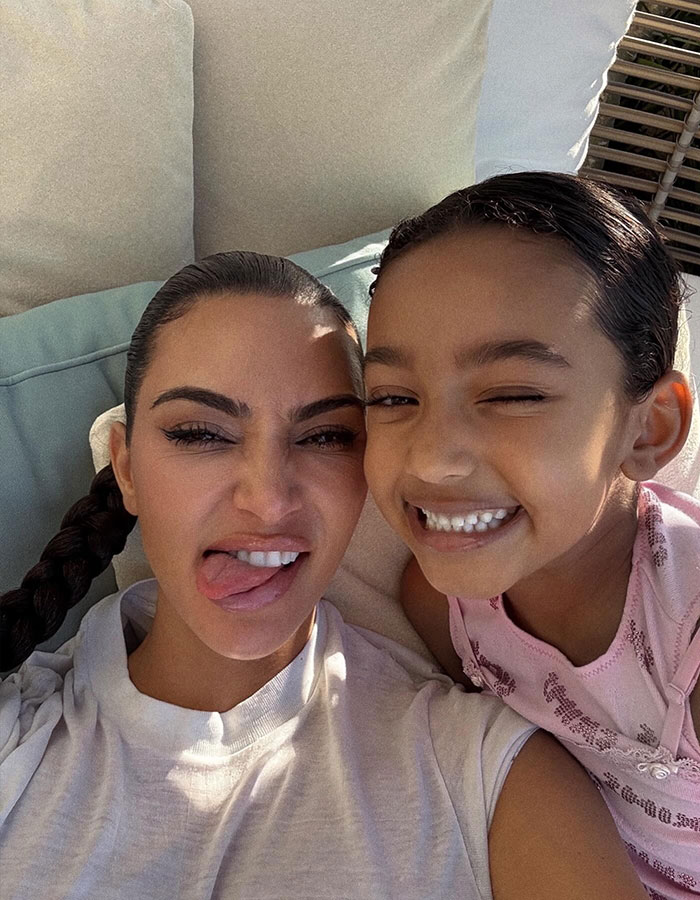 Kim Kardashian and her daughter smiling in a throwback selfie sparking discussions about plastic surgeries and natural beauty. Kim Kardashian and her daughter smiling in a throwback selfie sparking discussions about plastic surgeries and natural beauty.