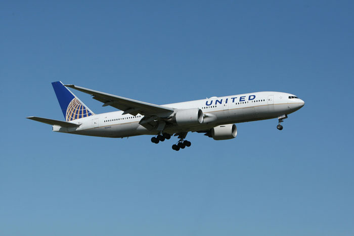 United Airlines airplane in flight representing a situation with an obese woman and flight attendant involvement. United Airlines airplane in flight representing a situation with an obese woman and flight attendant involvement.