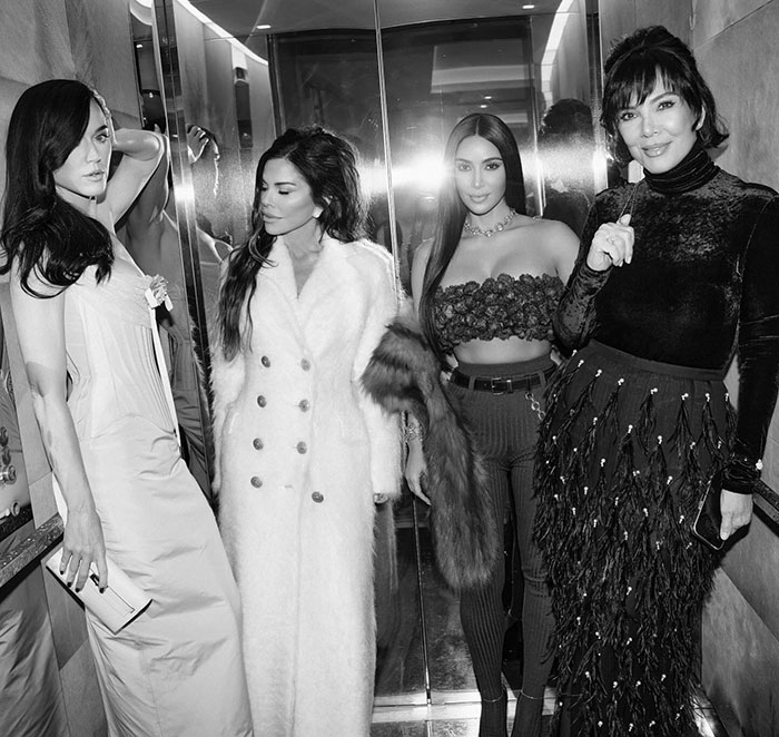 Four elegantly dressed women pose inside a reflective elevator, capturing the lavish wedding atmosphere of Jeff Bezos and Lauren Sanchez. Four elegantly dressed women pose inside a reflective elevator, capturing the lavish wedding atmosphere of Jeff Bezos and Lauren Sanchez.