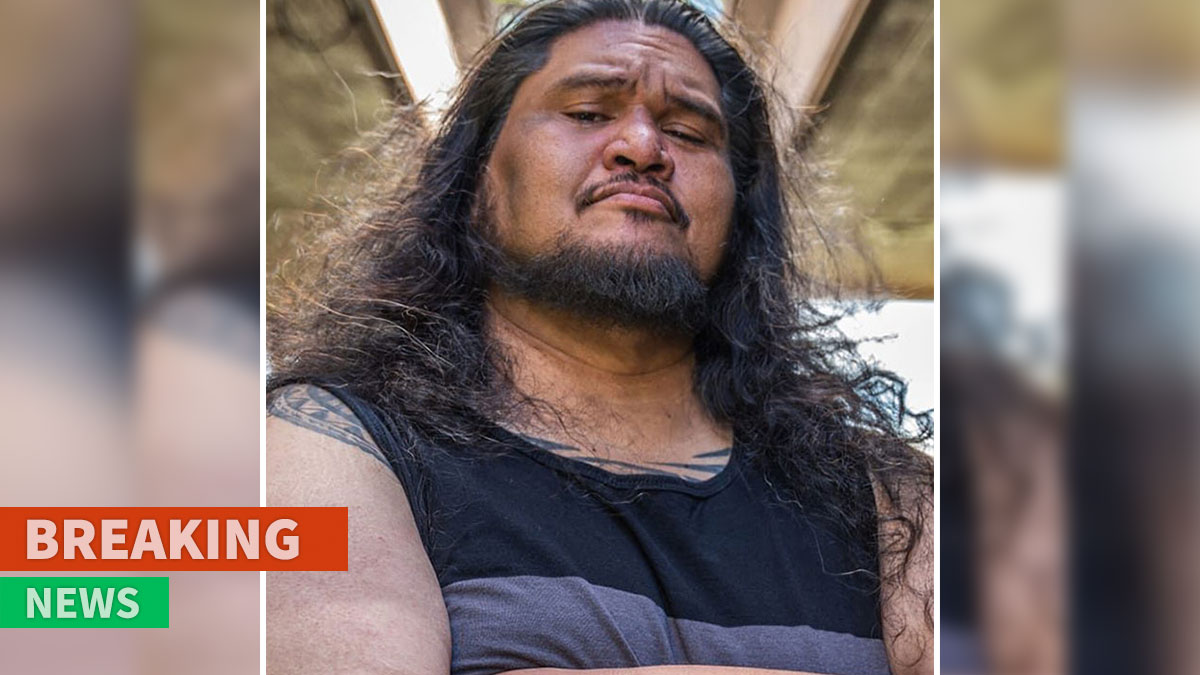 Actor David Hekili Kenui Bell with long hair and beard, featured in Lilo & Stitch, pictured in a casual sleeveless shirt.