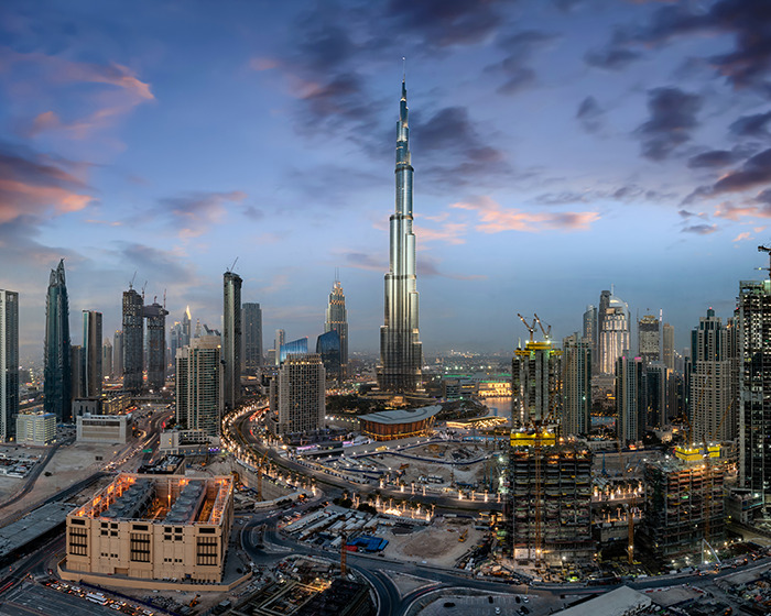 Skyline of a city at dusk with tall buildings, representing a man with face tattoos devastated after immigration officials' decision. Skyline of a city at dusk with tall buildings, representing a man with face tattoos devastated after immigration officials' decision.