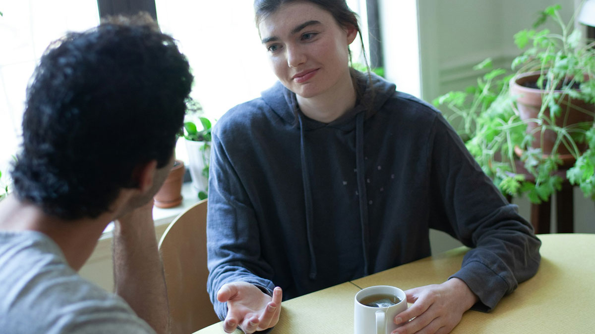 Woman talks about moving in while boyfriend insists on splitting bills 50/50 during serious discussion at kitchen table