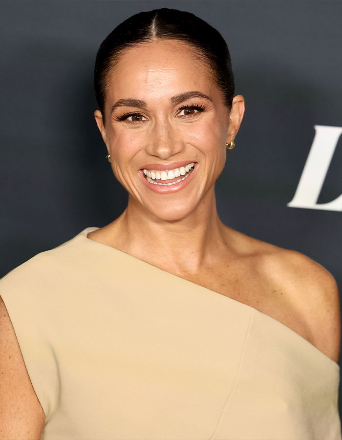 Meghan Markle smiling at event, wearing beige off-shoulder dress, linked to viral pregnancy twerk video mastermind plan. Meghan Markle smiling at event, wearing beige off-shoulder dress, linked to viral pregnancy twerk video mastermind plan.
