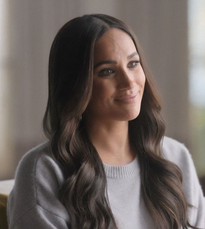 Meghan Markle smiling softly indoors with long wavy hair, linked to twerking pregnancy video and birth conspiracy theory. Meghan Markle smiling softly indoors with long wavy hair, linked to twerking pregnancy video and birth conspiracy theory.