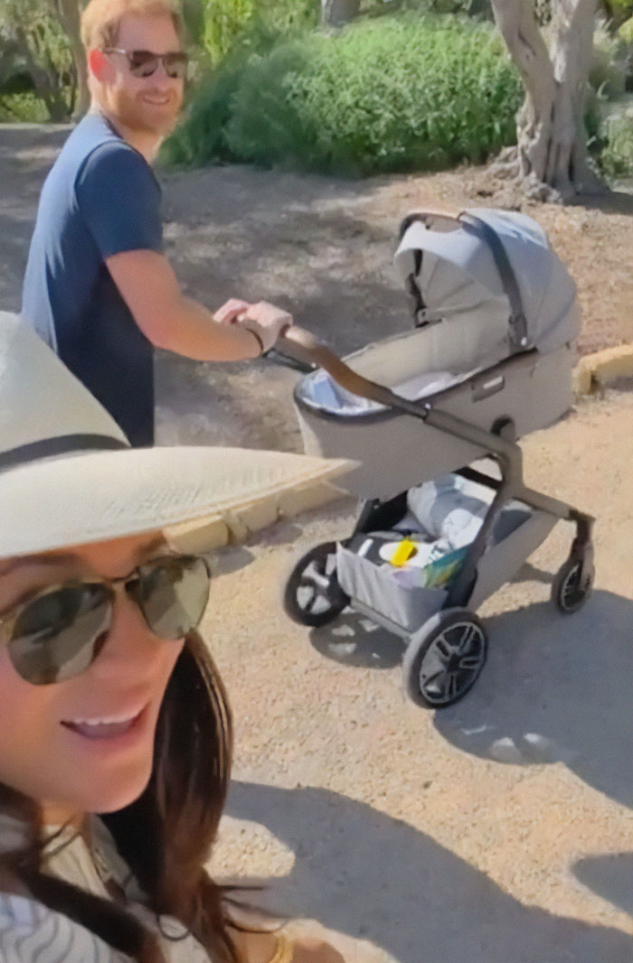 Meghan Markle with Prince Harry outdoors pushing a stroller, sparking twerking pregnancy conspiracy theory discussion. Meghan Markle with Prince Harry outdoors pushing a stroller, sparking twerking pregnancy conspiracy theory discussion.