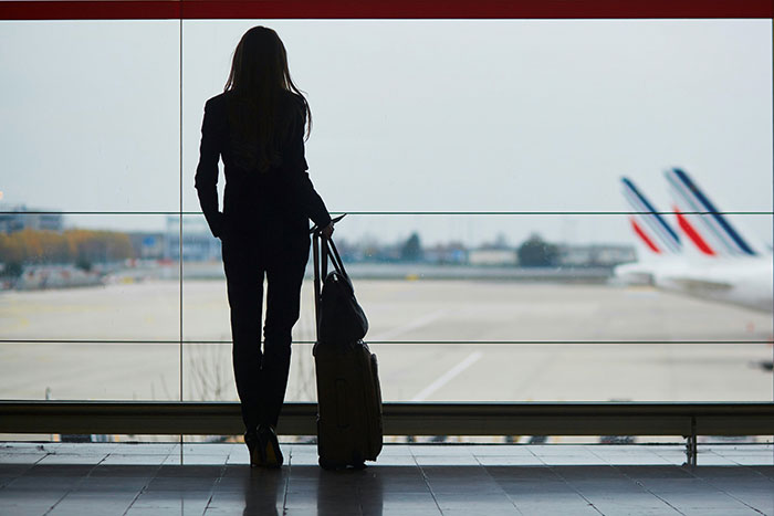 Silhouette of a woman at airport with luggage, symbolizing an absent grandma trying to reconnect after many years. Silhouette of a woman at airport with luggage, symbolizing an absent grandma trying to reconnect after many years.