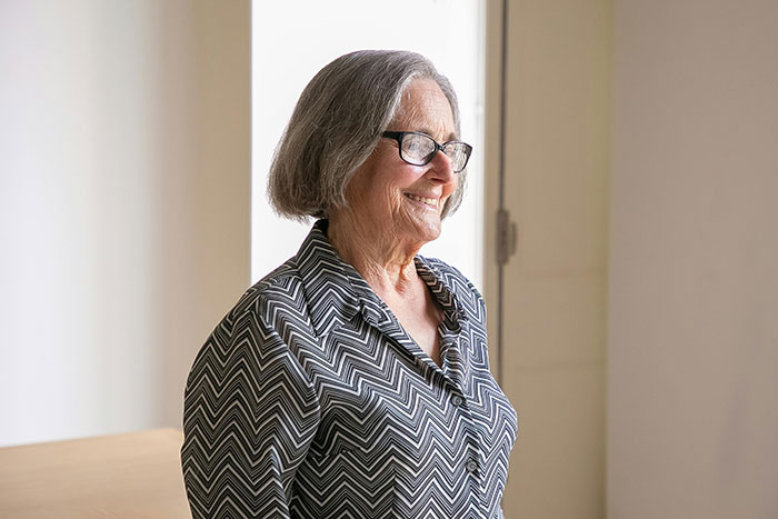 Elderly woman smiling softly indoors, symbolizing absent grandma attempting to reconnect after many years. Elderly woman smiling softly indoors, symbolizing absent grandma attempting to reconnect after many years.