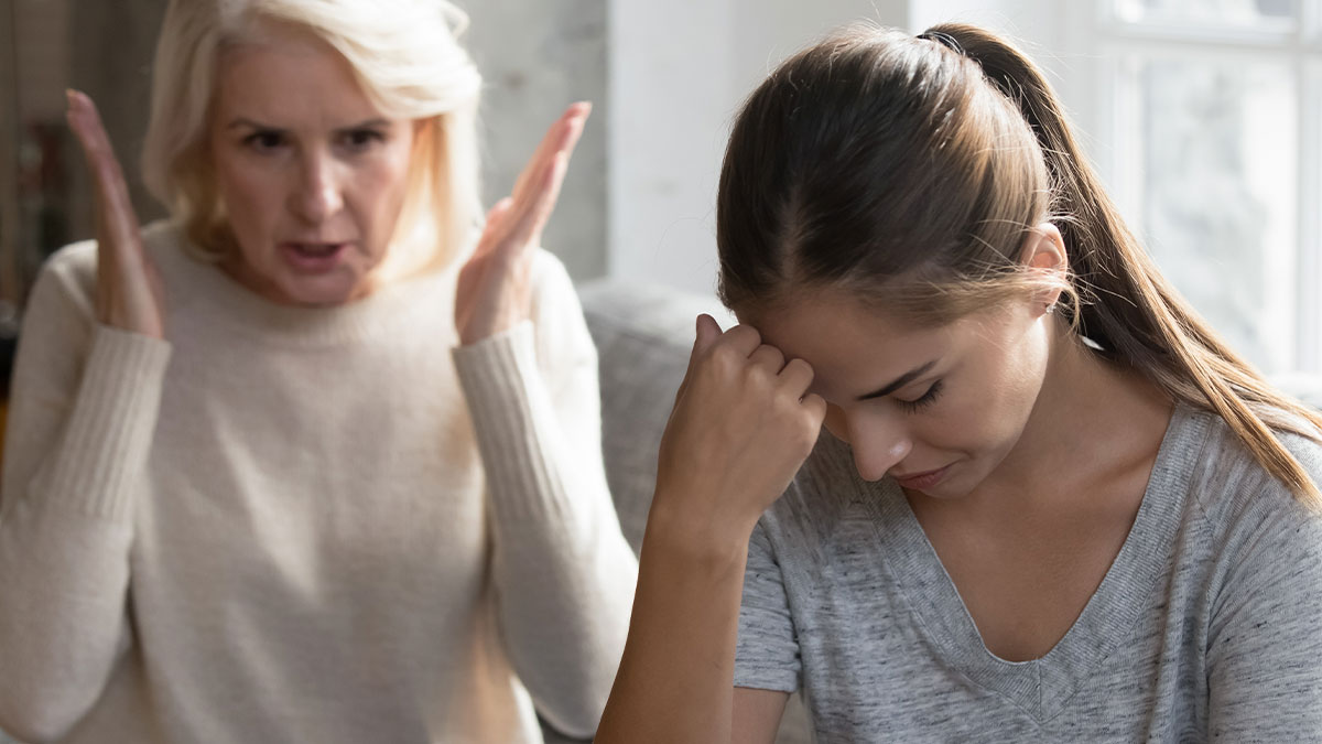 Older woman angrily gesturing while younger woman looks upset, depicting conflict and tension in mother-daughter relationship.