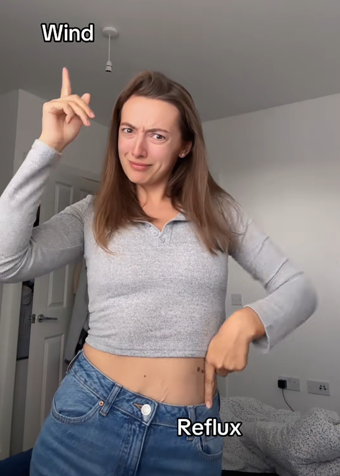 Woman pointing to stomach and head, illustrating common side effects of Mounjaro weight loss treatment. Woman pointing to stomach and head, illustrating common side effects of Mounjaro weight loss treatment.