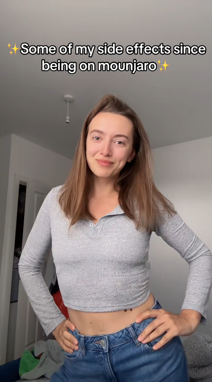 Young woman standing in a casual gray top and jeans sharing her side effects after using Mounjaro for weight loss. Young woman standing in a casual gray top and jeans sharing her side effects after using Mounjaro for weight loss.