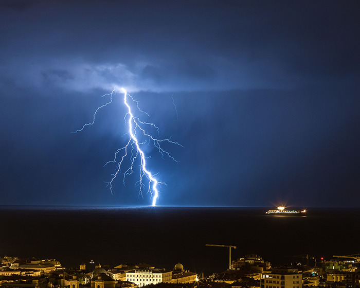 Lightning striking over water at night during storm, illustrating tragedy risk on newlywed’s honeymoon near ankle-deep water. Lightning striking over water at night during storm, illustrating tragedy risk on newlywed’s honeymoon near ankle-deep water.