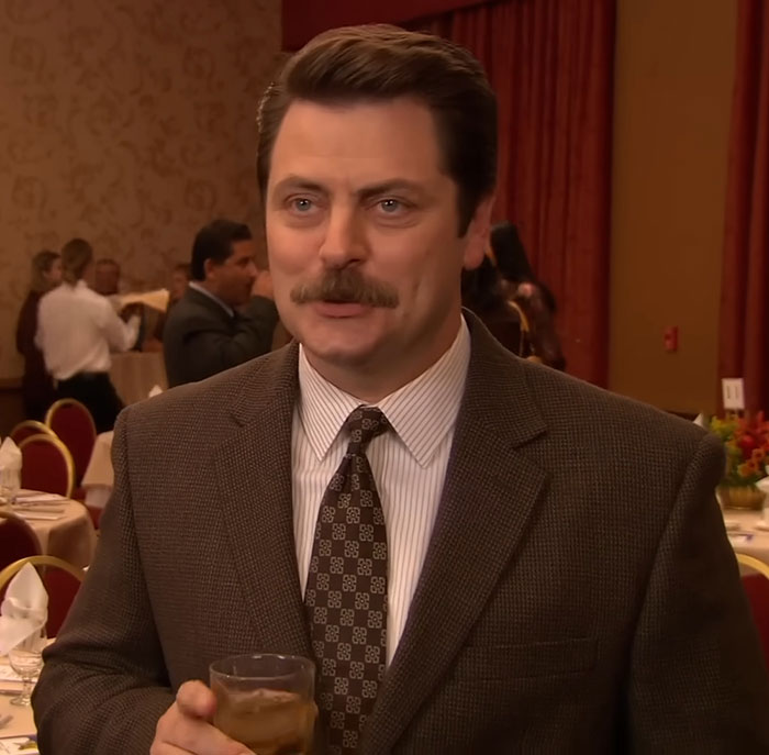 Nick Offerman in a brown suit at a formal event, delivering a praised brutal clapback against homophobe. Nick Offerman in a brown suit at a formal event, delivering a praised brutal clapback against homophobe.