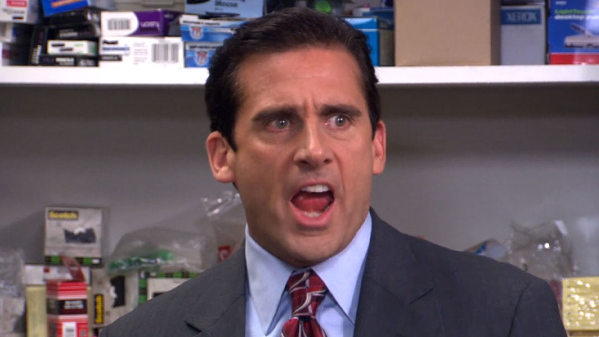 Man in a suit with an expressive face, captured during a heated moment related to absurd legal claims.