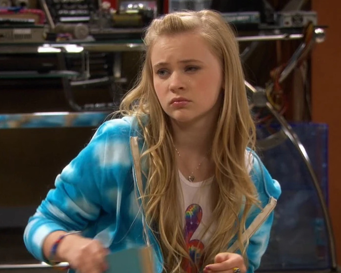 Teen girl wearing a blue hoodie looking pensive, illustrating child star's unrecognizable transformation and sinister Disney pattern concerns. Teen girl wearing a blue hoodie looking pensive, illustrating child star's unrecognizable transformation and sinister Disney pattern concerns.