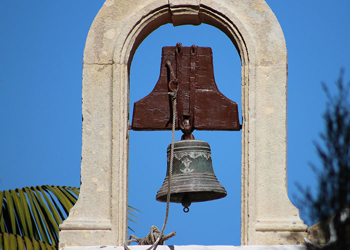 Old bronze bell hanging in a stone arch structure, symbolizing secrets and confessions shared anonymously. Old bronze bell hanging in a stone arch structure, symbolizing secrets and confessions shared anonymously.
