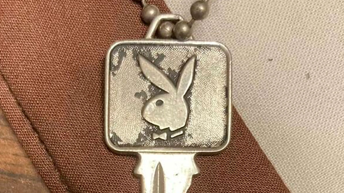 Worn silver key with a rabbit logo found among surprising things discovered in walls and hidden places
