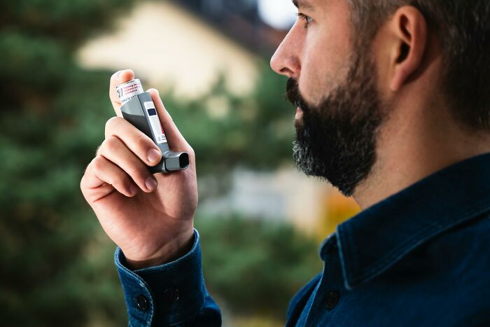 Close-up of a man using an inhaler, illustrating moments of people ruining their life with one wrong deed.