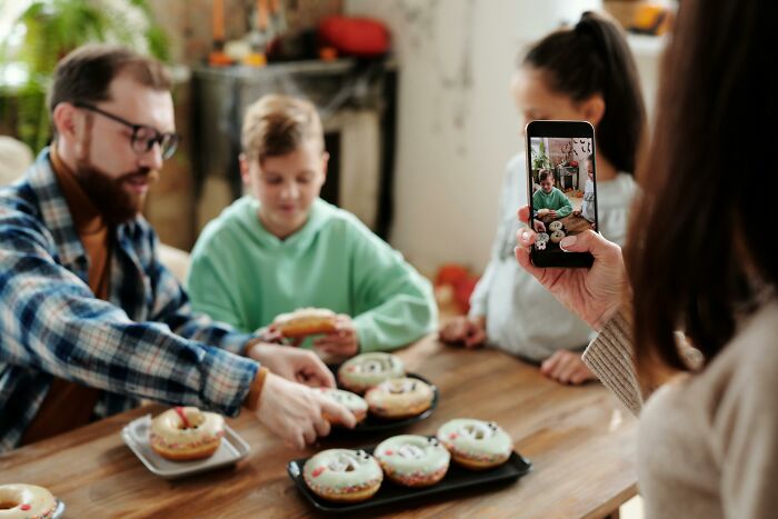 Family sharing knowledge while enjoying donuts.