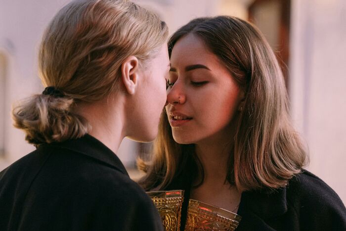 Two women intimately close, portraying a moment.